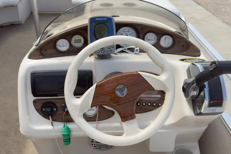 Slide: The Image of Steering console of a 2007 Harris Sunliner 220 boat with gauges and controls. - 9