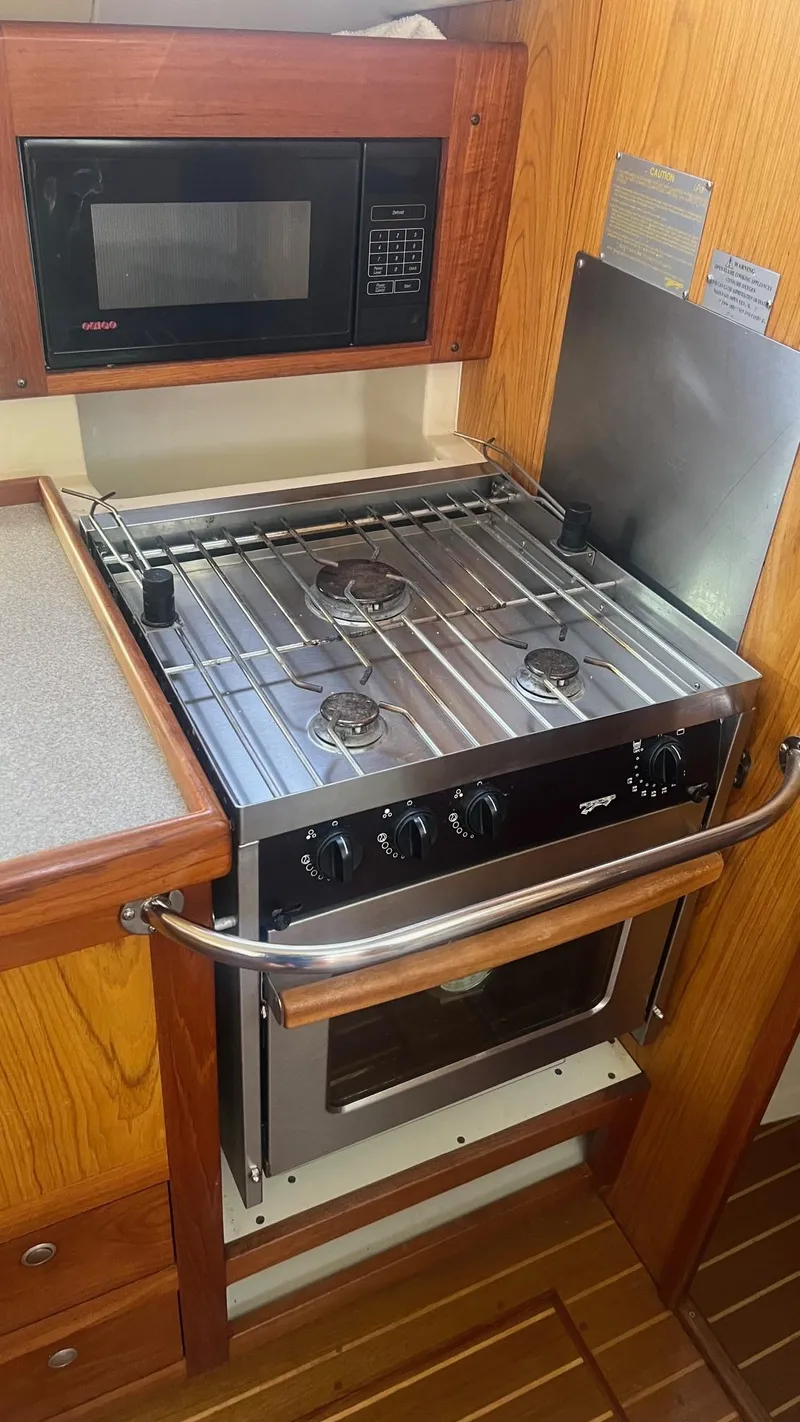 Slide: The Image of Stainless steel stove and microwave in a 2000 Hunter 410 yacht kitchen. - 13