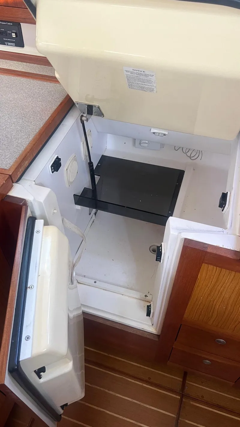 Slide: The Image of Open refrigerator in a 2000 Hunter 410 yacht kitchen interior. - 14