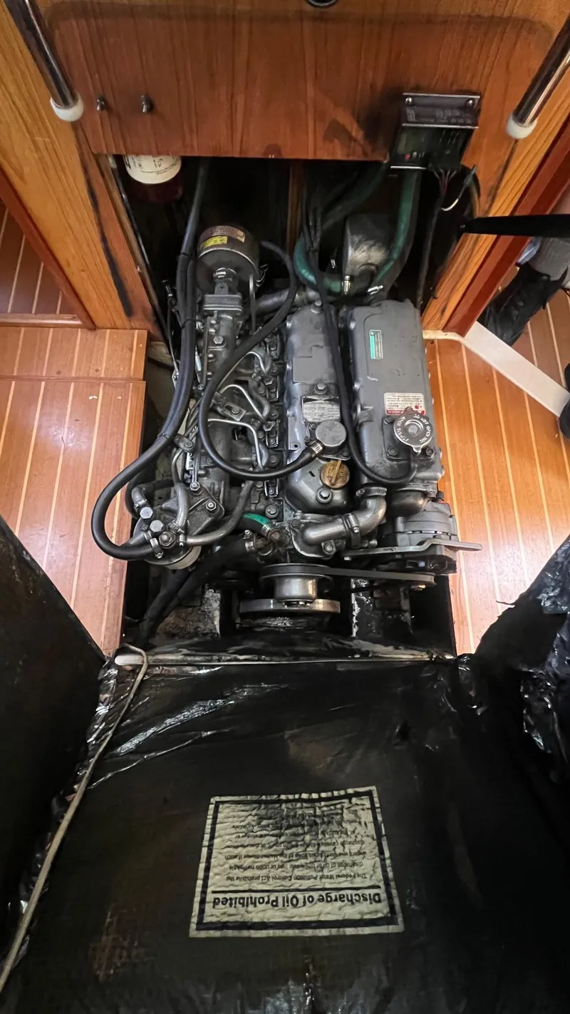 Slide: The Image of Engine compartment of a 2000 Hunter 410 sailboat, showcasing detailed mechanical components. - 18