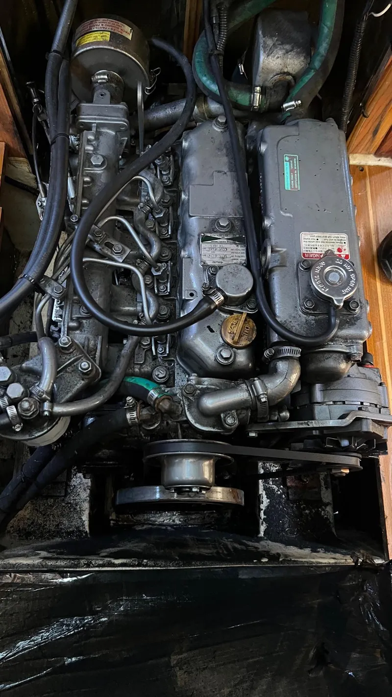 Slide: The Image of Engine of a 2000 Hunter 410 sailboat, showcasing intricate mechanical components. - 19