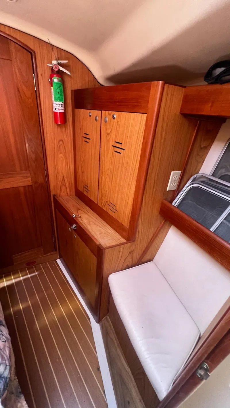 Slide: The Image of Interior of 2000 Hunter 410 sailboat with wooden cabinetry and seating. - 21