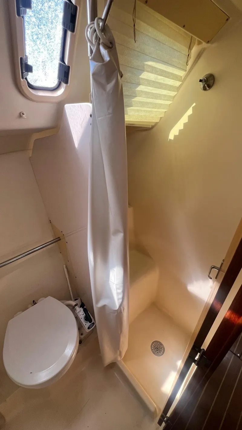 Slide: The Image of Compact bathroom in a 2000 Hunter 410 boat with shower and toilet. - 26