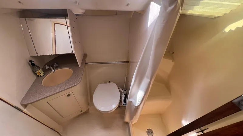 Slide: The Image of Compact bathroom in a 2000 Hunter 410 yacht with sink, toilet, and shower. - 27