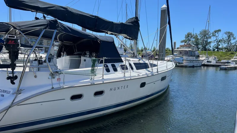 Slide: The Image of Sailboat Hunter 410, 2000 model, docked in a marina on a sunny day. - 3