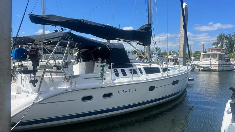 Slide: The Image of Sailboat docked in marina, 2000 Hunter 410 model, clear sky background. - 34