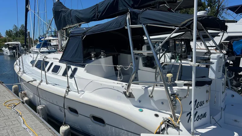 Slide: The Image of Sailboat docked at marina, Hunter 410 model, year 2000, with black canopy. - 39