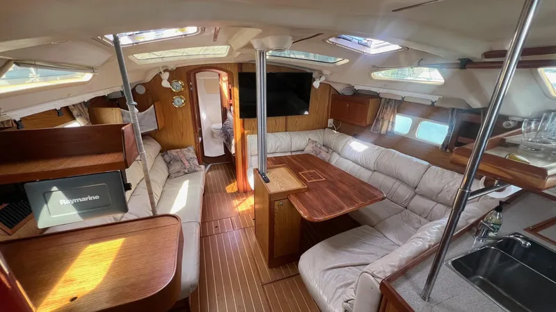 Slide: The Image of Spacious interior of 2000 Hunter 410 sailboat with cozy seating and wooden finishes. - 4