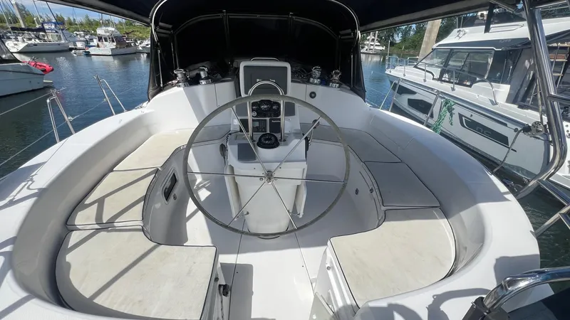 Slide: The Image of Cockpit of 2000 Hunter 410 sailboat with steering wheel and seating, docked at marina. - 40
