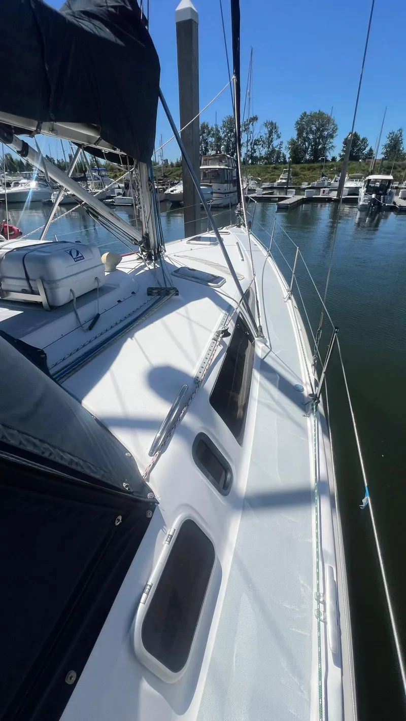 Slide: The Image of Sailboat docked at marina, Hunter 410 model, year 2000, under clear blue sky. - 42