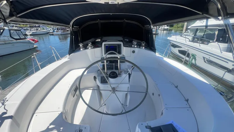 Slide: The Image of Cockpit of 2000 Hunter 410 sailboat with steering wheel and navigation equipment. - 46