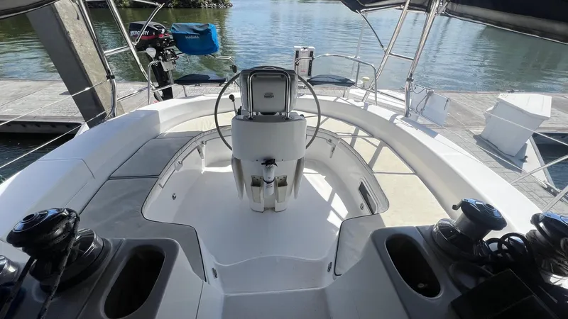 Slide: The Image of Cockpit of 2000 Hunter 410 sailboat with steering wheel and winches, docked by the water. - 47