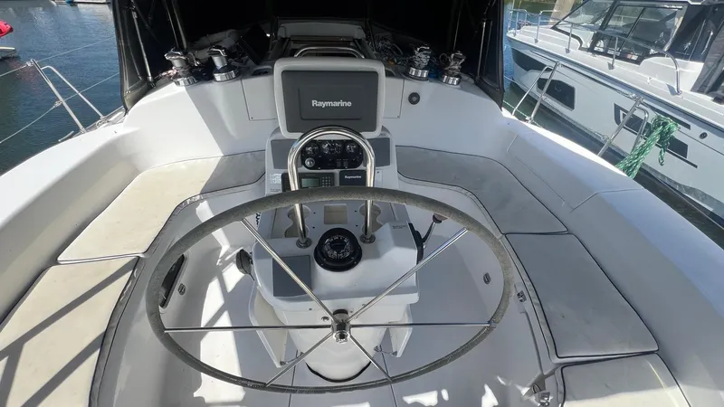 Slide: The Image of Cockpit of 2000 Hunter 410 sailboat with steering wheel and navigation equipment. - 48