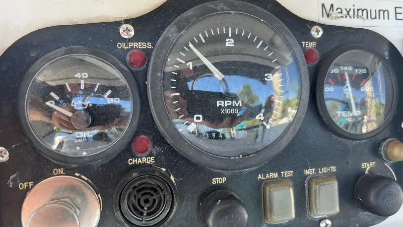 Slide: The Image of Control panel of a 2000 Hunter 410 boat, featuring RPM and temperature gauges. - 50