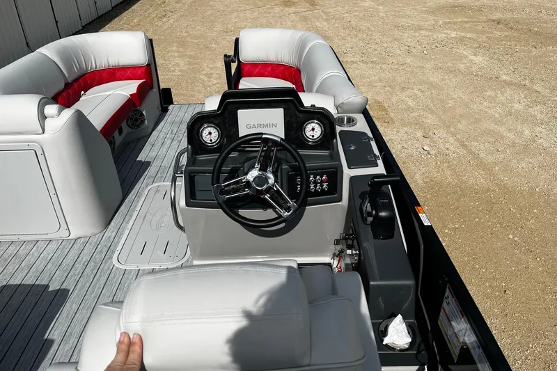 Slide: The Image of 2025 SunCatcher ELITE 324RC boat interior with steering wheel and seating. - 11