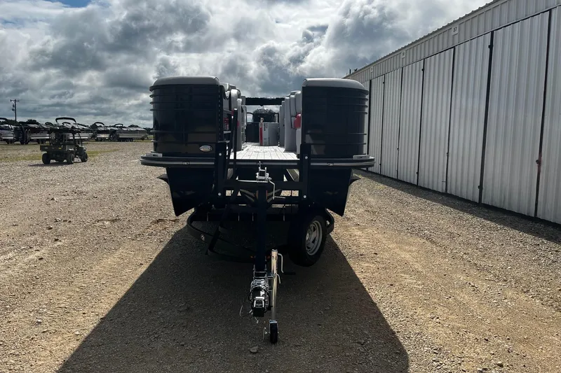 Slide: The Image of 2025 SunCatcher ELITE 324RC pontoon boat on trailer, parked outdoors. - 3