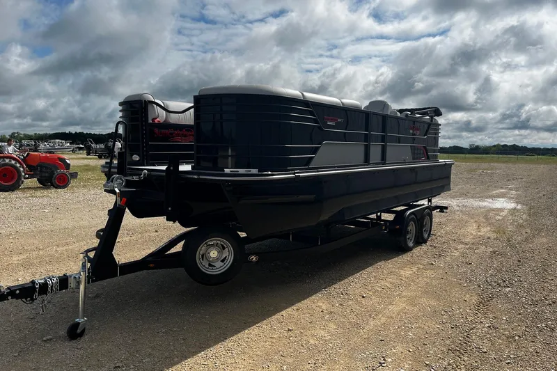 Slide: The Image of 2025 SunCatcher ELITE 324RC pontoon boat on trailer under cloudy sky. - 4