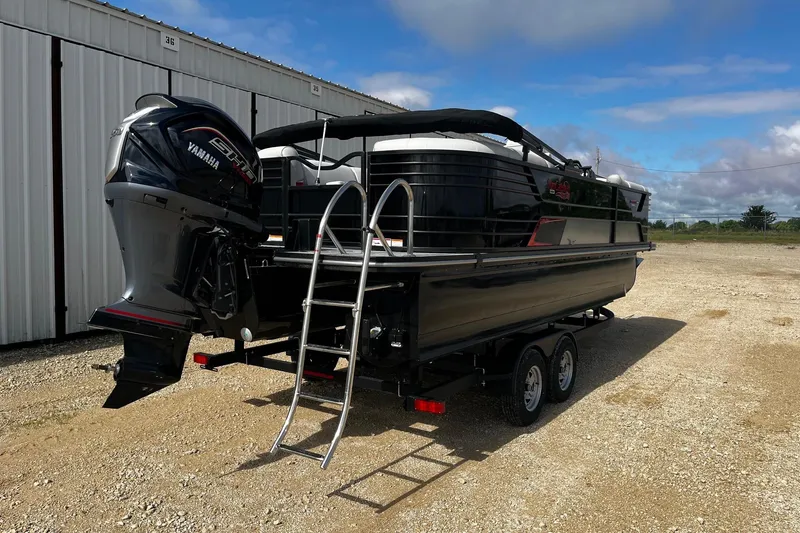 Slide: The Image of 2025 SunCatcher ELITE 324RC pontoon boat on trailer with Yamaha engine, parked outdoors. - 8