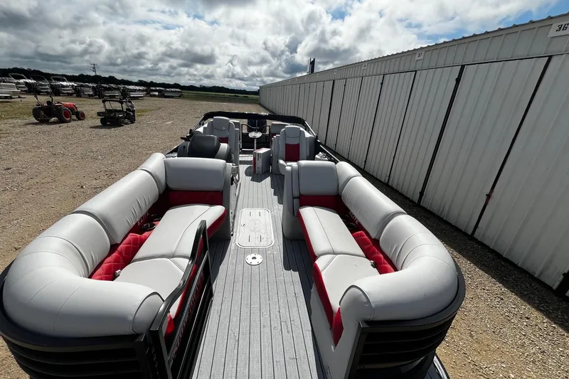 Slide: The Image of 2025 SunCatcher ELITE 324RC pontoon boat with spacious seating, parked outdoors. - 9