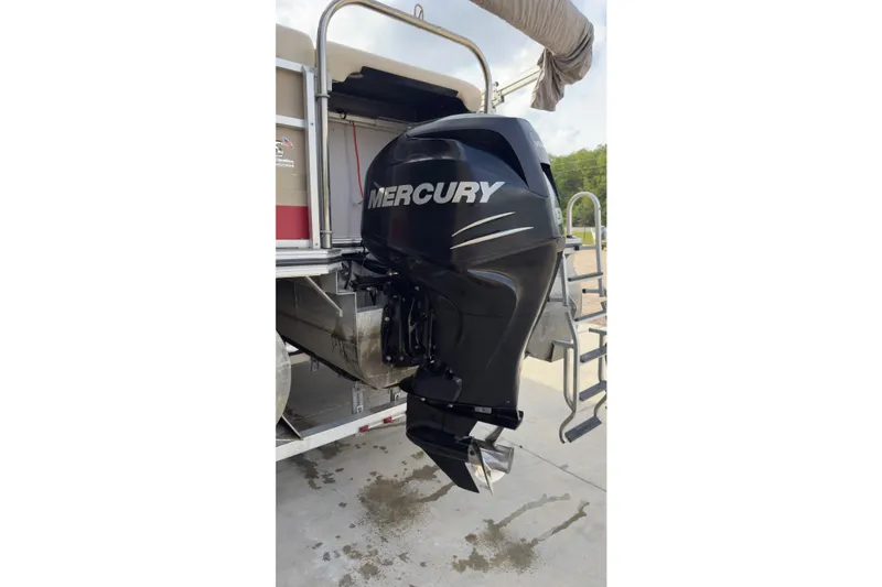 Slide: The Image of 2008 Harris Super Sunliner 220 with Mercury outboard motor, docked with ladder. - 11
