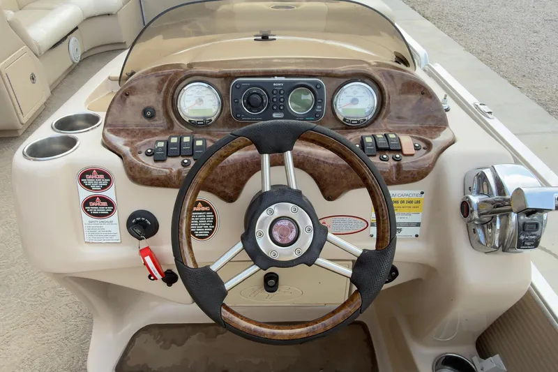 Slide: The Image of 2008 Harris Super Sunliner 220 boat dashboard with steering wheel and control panel. - 3