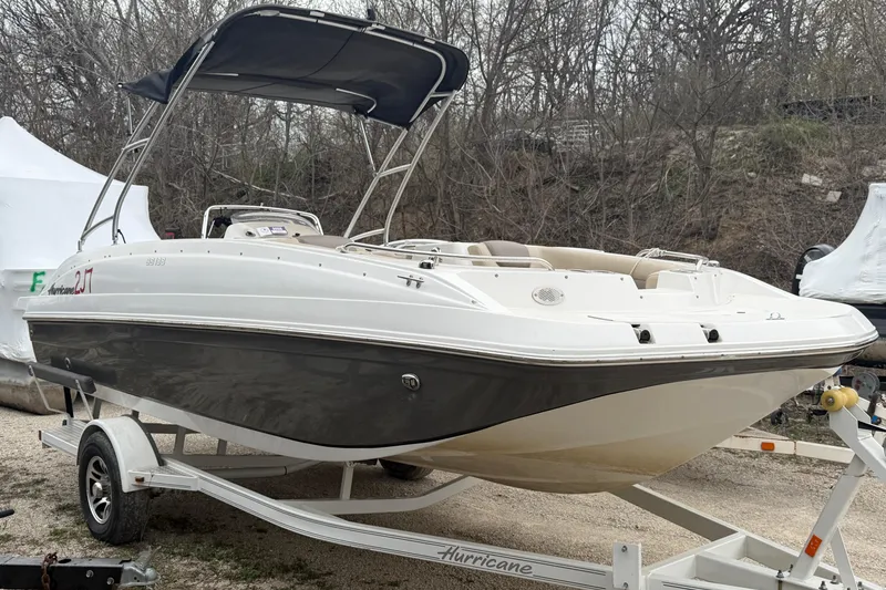 Slide: The Image of 2016 Hurricane SunDeck Sport 188 IO boat on trailer, parked outdoors. - 1