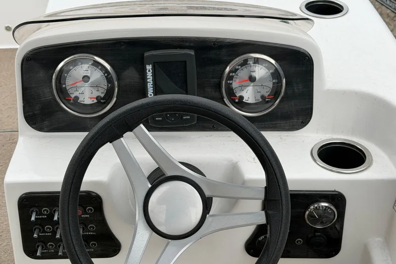 Slide: The Image of 2016 Hurricane SunDeck Sport 188 IO dashboard with steering wheel and gauges. - 13