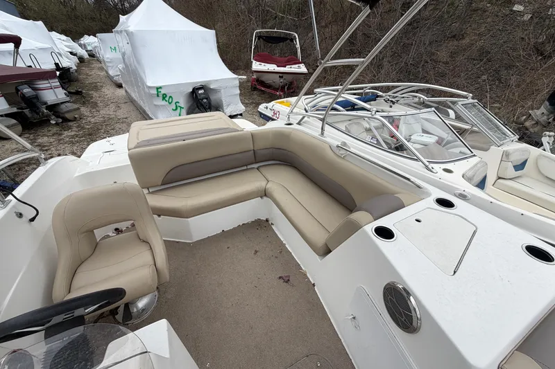 Slide: The Image of 2016 Hurricane SunDeck Sport 188 IO boat interior with beige seating and steering wheel. - 5