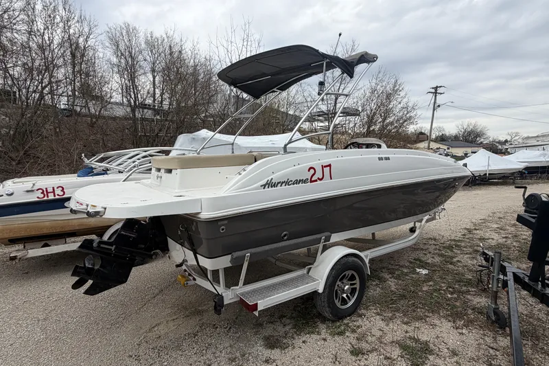 Slide: The Image of 2016 Hurricane SunDeck Sport 188 IO boat on trailer, parked outdoors. - 7