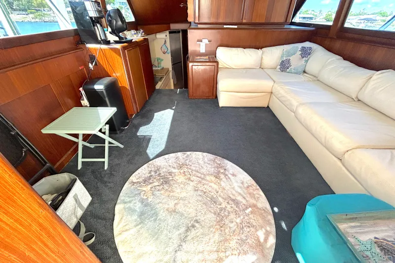 Slide: The Image of Interior of 1989 Hatteras 45 Convertible yacht with cozy seating and modern amenities. - 14