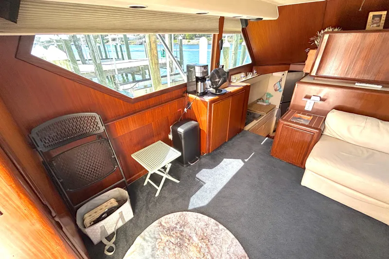 Slide: The Image of Interior of 1989 Hatteras 45 Convertible yacht with wood paneling and seating area. - 16