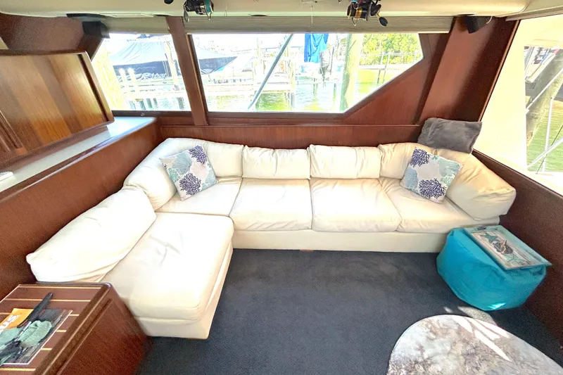 Slide: The Image of Luxurious interior of 1989 Hatteras 45 Convertible yacht with white sectional sofa. - 20