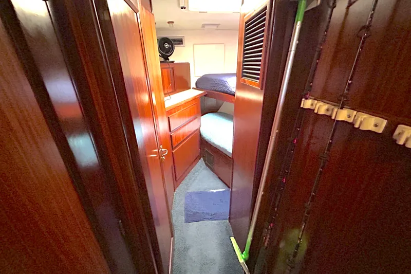 Slide: The Image of Interior of 1989 Hatteras 45 Convertible yacht with wooden cabinetry and bunk beds. - 28