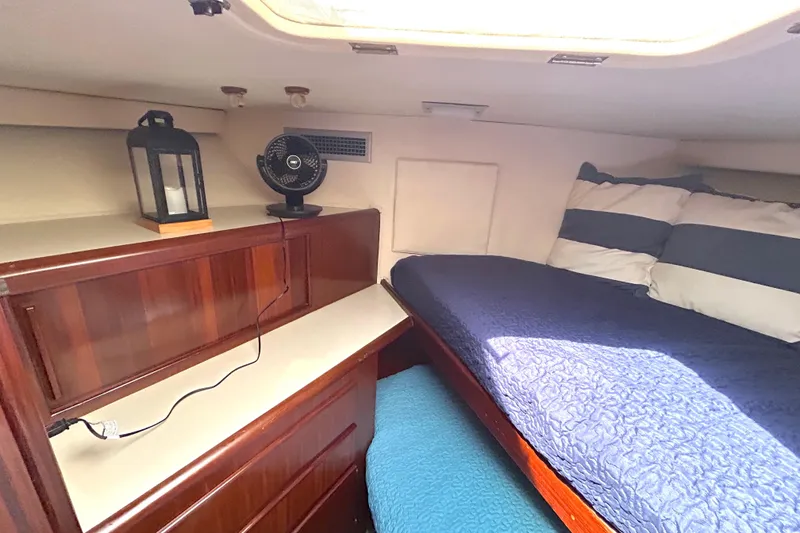 Slide: The Image of 1989 Hatteras 45 Convertible cabin interior with bed, fan, and lantern. - 30