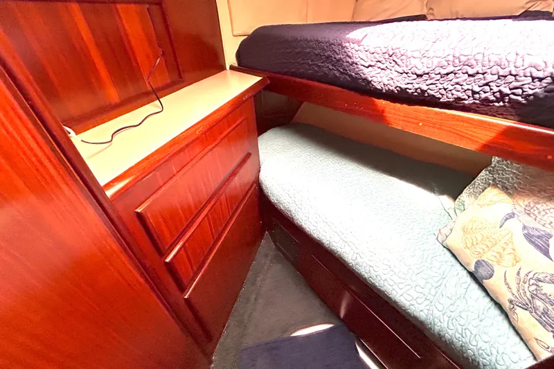 Slide: The Image of Cozy cabin interior of 1989 Hatteras 45 Convertible with wooden drawers and bunk beds. - 31