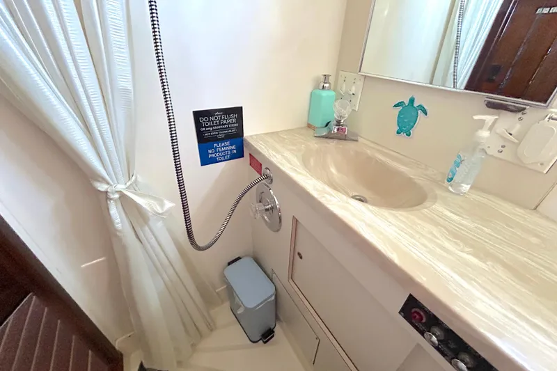 Slide: The Image of Bathroom interior of 1989 Hatteras 45 Convertible yacht with sink and toiletries. - 34