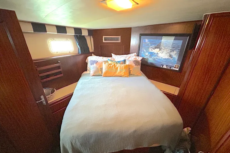 Slide: The Image of Cozy bedroom in 1989 Hatteras 45 Convertible yacht with nautical decor. - 35