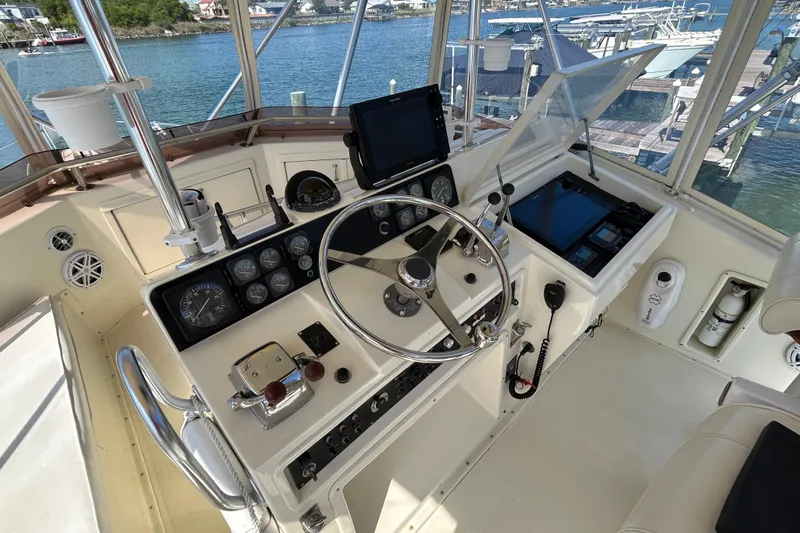 Slide: The Image of 1989 Hatteras 45 Convertible yacht helm with steering wheel and navigation instruments. - 42