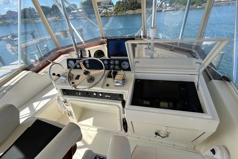 Slide: The Image of Helm of 1989 Hatteras 45 Convertible yacht with steering wheel and navigation equipment. - 45