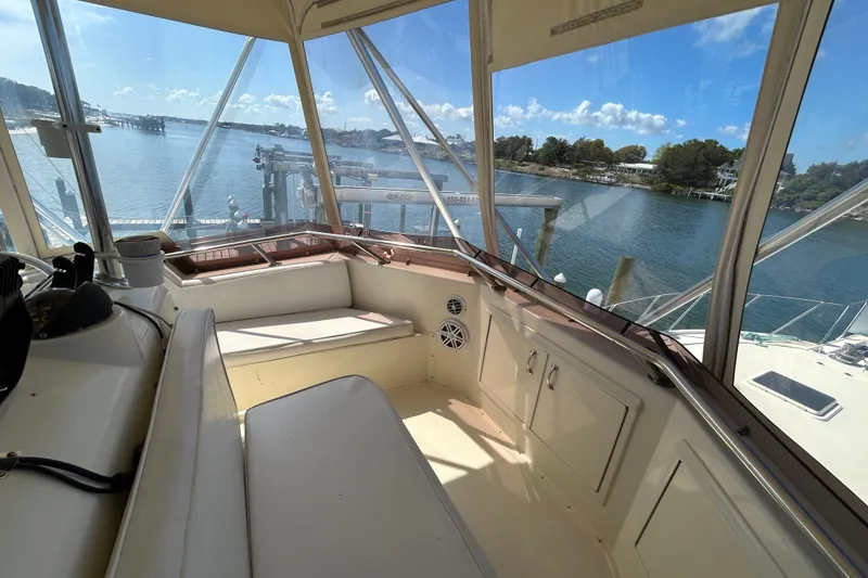 Slide: The Image of Interior view of 1989 Hatteras 45 Convertible yacht with scenic waterfront backdrop. - 47