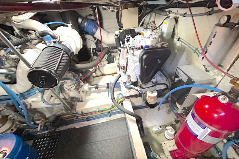 Slide: The Image of Engine room of a 1989 Hatteras 45 Convertible yacht, showcasing mechanical components. - 50