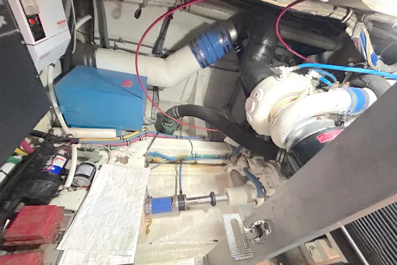 Slide: The Image of Engine room of a 1989 Hatteras 45 Convertible boat, showcasing mechanical components. - 51