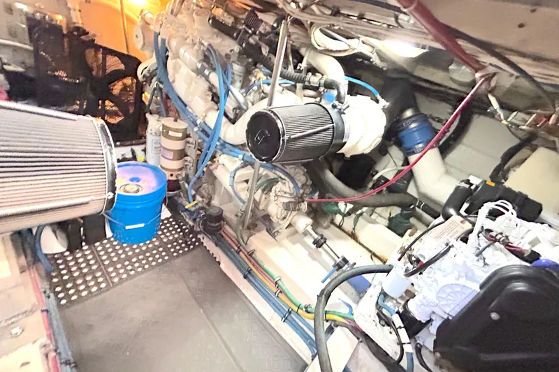 Slide: The Image of Engine room of a 1989 Hatteras 45 Convertible yacht, showcasing mechanical components. - 52