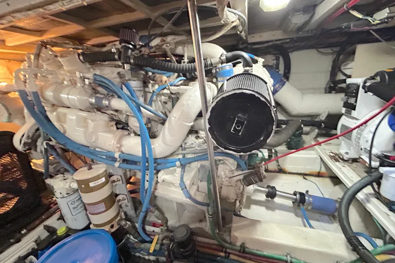 Slide: The Image of Engine room of a 1989 Hatteras 45 Convertible yacht, showcasing mechanical components. - 53