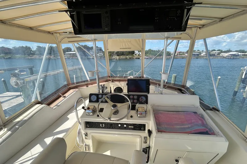 Slide: The Image of 1989 Hatteras 45 Convertible yacht helm with panoramic water view. - 55