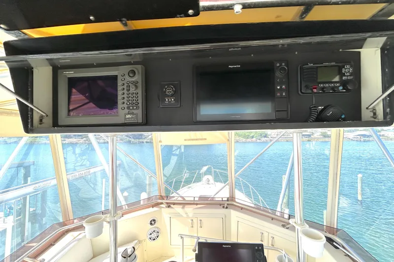 Slide: The Image of Bridge of 1989 Hatteras 45 Convertible yacht with navigation equipment and ocean view. - 58