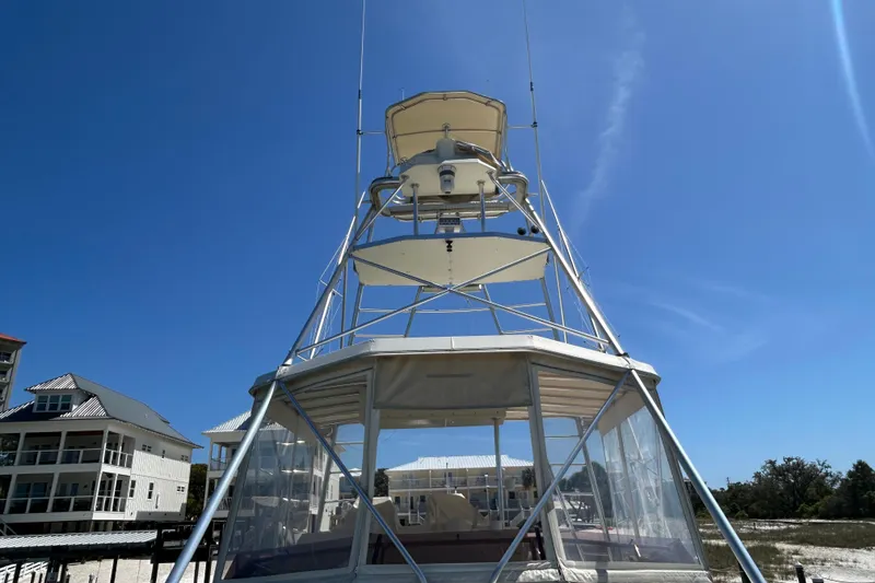Slide: The Image of 1989 Hatteras 45 Convertible yacht tower against clear blue sky. - 49