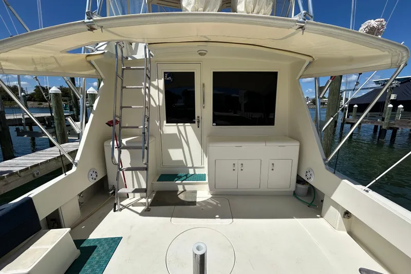 Slide: The Image of 1989 Hatteras 45 Convertible yacht deck with ladder and storage cabinets. - 6