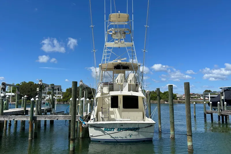 Slide: The Image of 1989 Hatteras 45 Convertible yacht docked under clear blue sky. - 2
