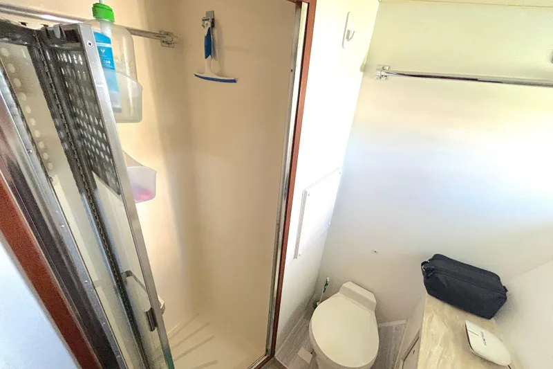Slide: The Image of Bathroom interior of 1989 Hatteras 45 Convertible yacht, featuring shower and toilet. - 45